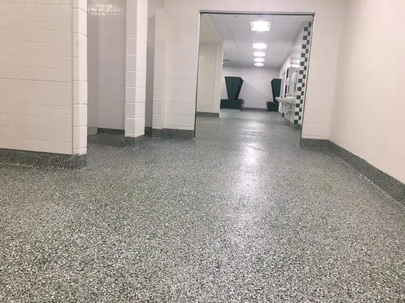 Flake epoxy floor with a cove base in a commercial restroom