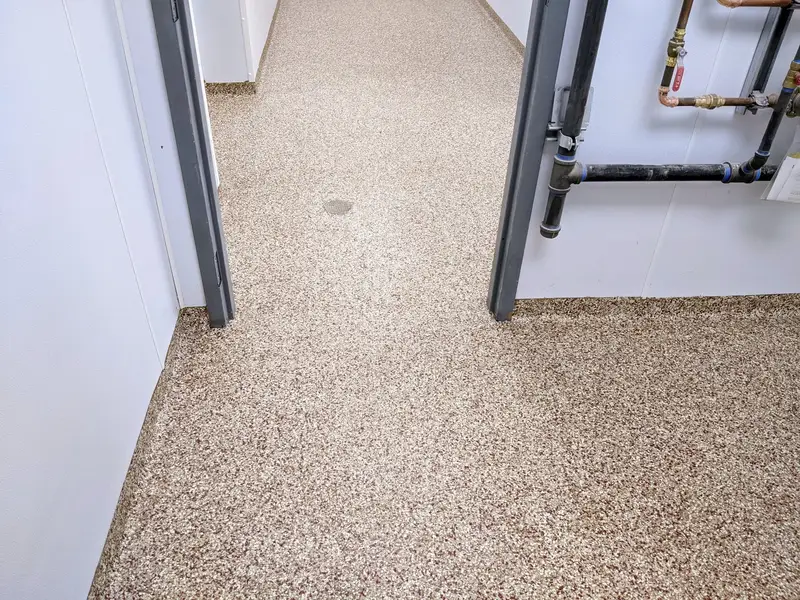 Tan flake epoxy floor in a utility room