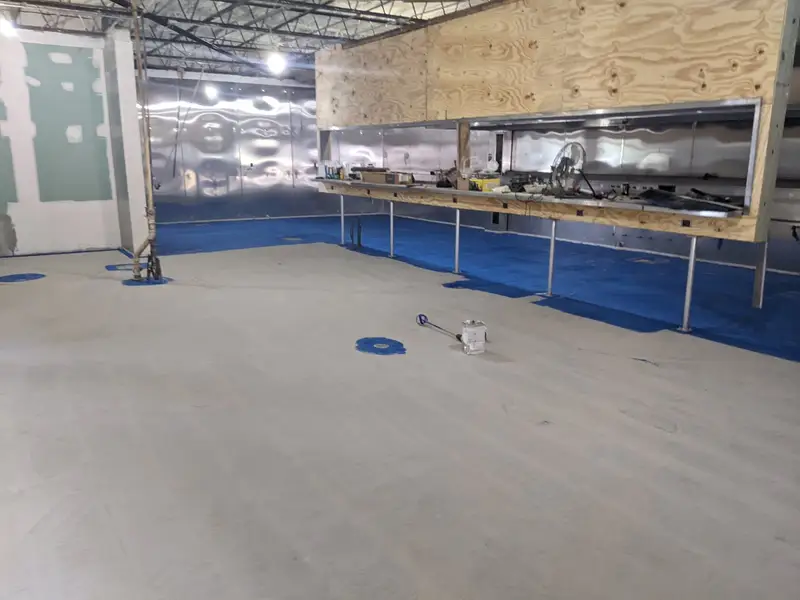 Epoxy floor installation in progress in a commercial space
