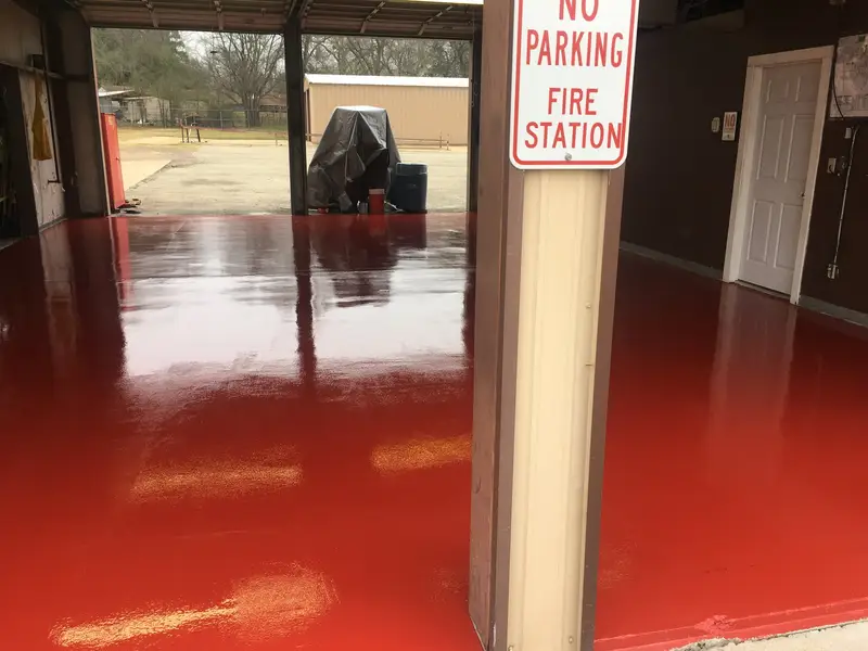 Red epoxy floor in a fire station bay