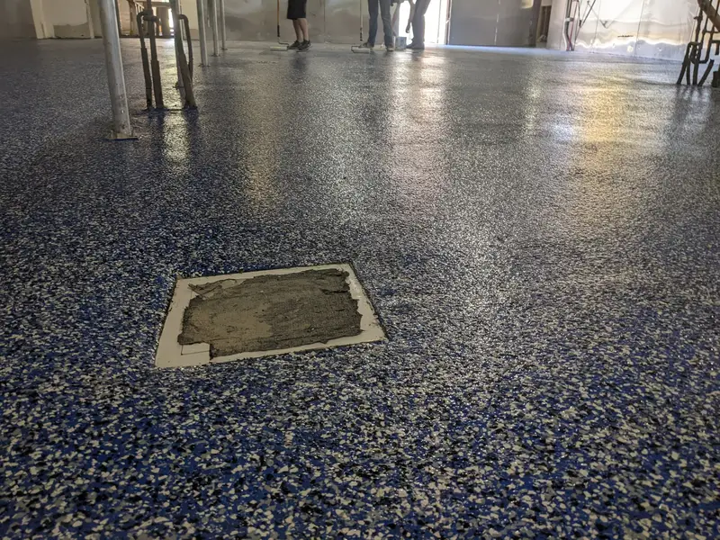 Blue flake epoxy floor in a commercial space