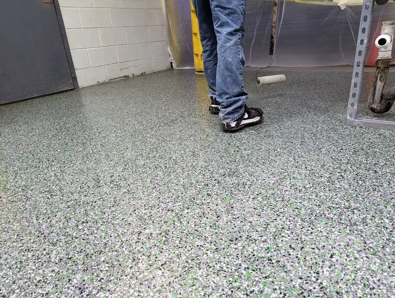 Flake epoxy floor being applied in a commercial space