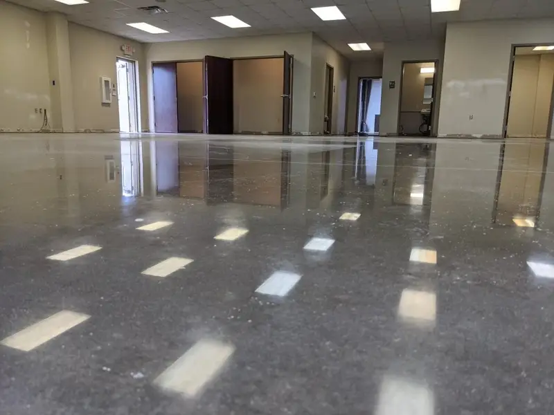 Polished concrete in an open office space reflecting overhead lights