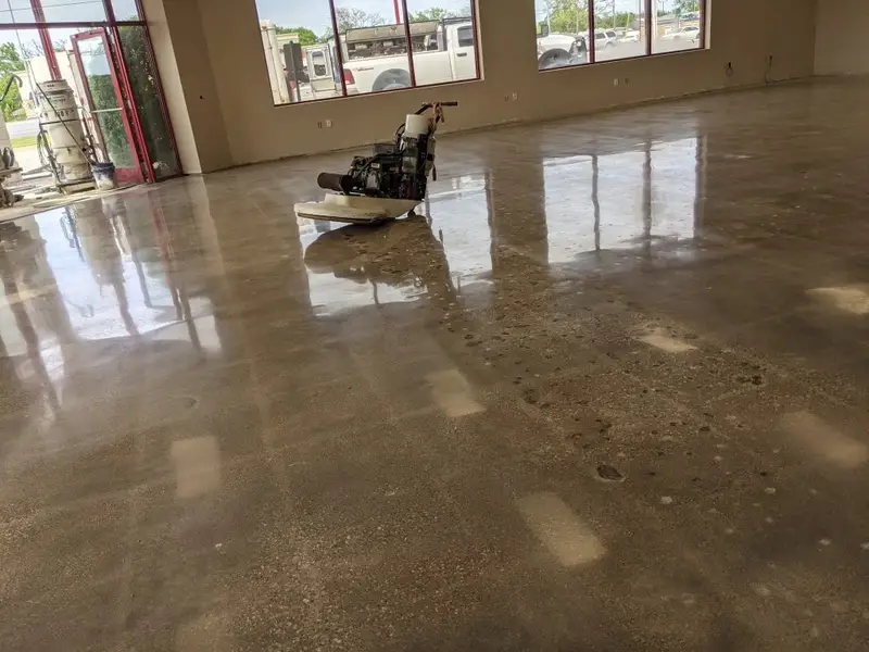 Polishing machine on a glossy concrete floor in a retail space