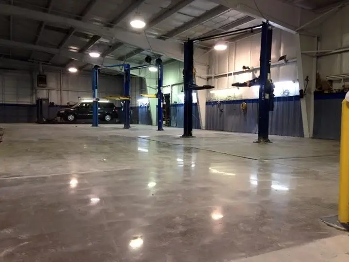 Polished concrete floor in an auto service shop with vehicle lifts
