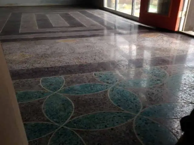 Polished terrazzo-style concrete with a decorative teal pattern