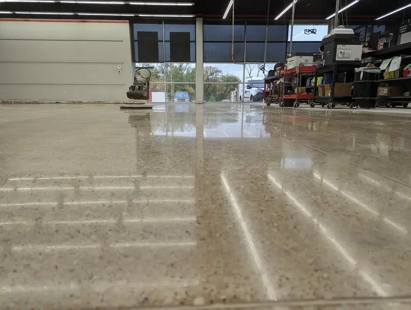 Polished concrete in a retail store reflecting light strips