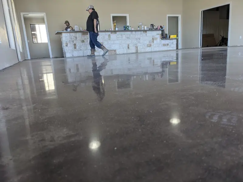 Polished concrete in an office lobby with a stone reception desk
