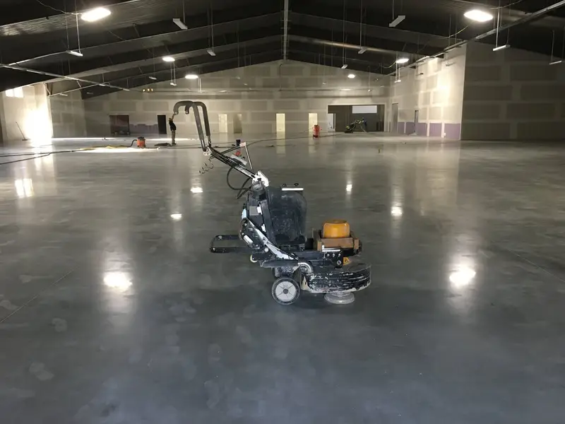 Concrete grinder on a polished warehouse floor