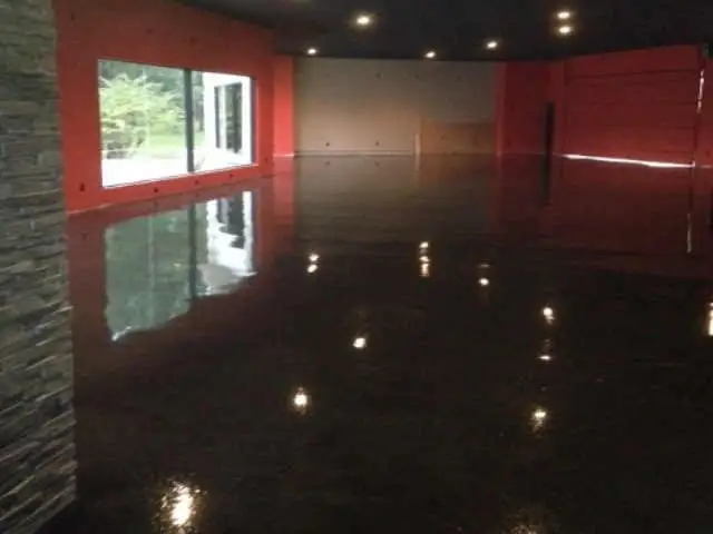Dark stained concrete with a high-gloss seal in a large room