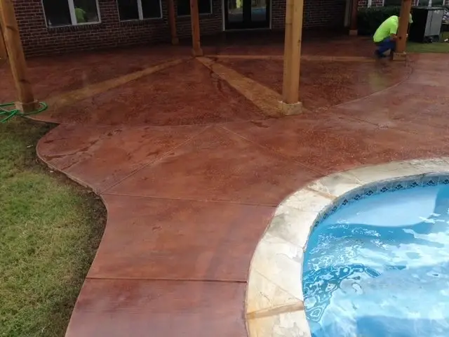 Stained concrete patio around a swimming pool