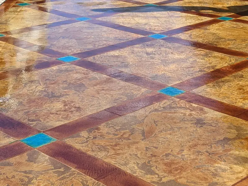 Stained concrete patio with a diamond grid and turquoise accents