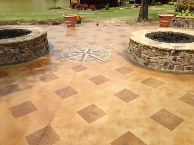 Stained concrete patio with fire pits and a compass design