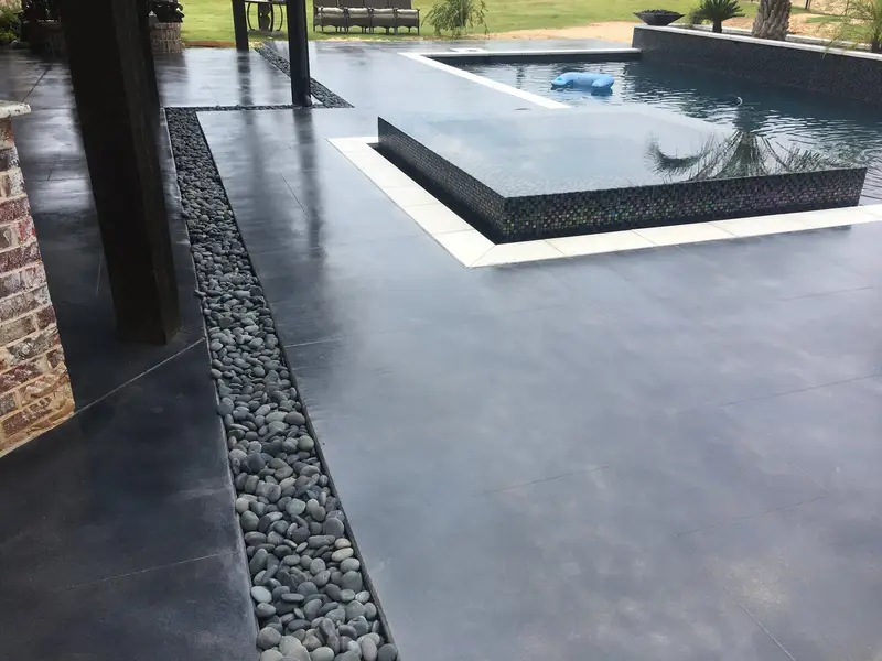 Charcoal stained concrete pool deck