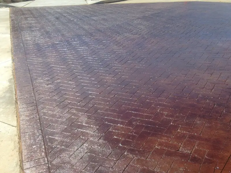 Stained concrete in a herringbone brick pattern