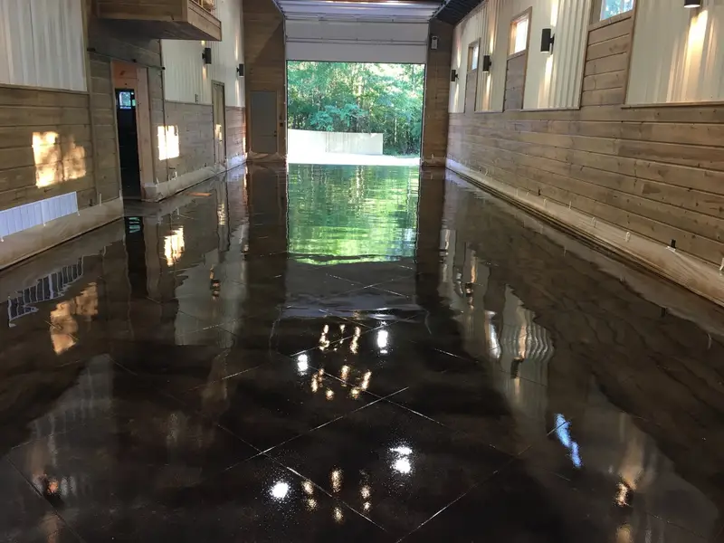 Dark stained concrete with a high-gloss finish in a breezeway