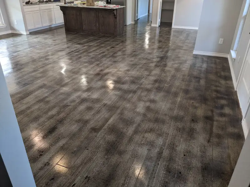 Gray wood-look concrete floor in an open kitchen and living area