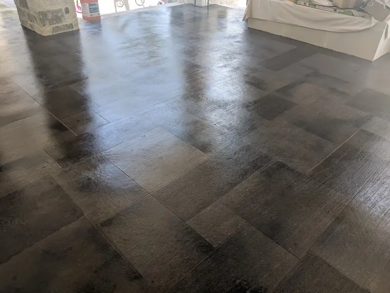 Dark wood-look concrete floor in a large room